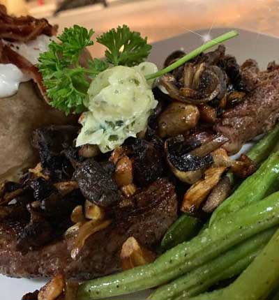 Dinner menu with Ribeye, green beans and baked potato